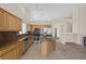 Modern kitchen with stainless steel appliances, tile flooring, granite counters, and an island at 7544 Coral River Dr, Las Vegas, NV 89131