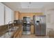 Well-lit kitchen with stainless steel appliances, a center island, and granite countertops at 7544 Coral River Dr, Las Vegas, NV 89131