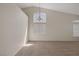 Bright, carpeted living room featuring vaulted ceilings and window with blinds at 7544 Coral River Dr, Las Vegas, NV 89131