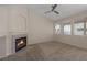 Inviting living room boasts a cozy fireplace, neutral tones, and ample natural light from multiple windows at 7544 Coral River Dr, Las Vegas, NV 89131