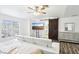 Bright bedroom features a seating area, barn door, and window at 7925 Limbwood Ct, Las Vegas, NV 89131