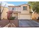Charming two-story home with a well-manicured lawn and a two-car garage at 7925 Limbwood Ct, Las Vegas, NV 89131