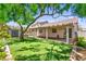 Lush backyard featuring a covered patio, storage shed, mature tree and manicured lawn at 8113 Danaides Ct, Las Vegas, NV 89131
