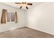 This bedroom features neutral carpet, a window and a ceiling fan with light at 8113 Danaides Ct, Las Vegas, NV 89131