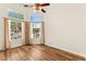 Spacious room featuring vaulted ceilings, large windows, and a ceiling fan with light fixture at 8113 Danaides Ct, Las Vegas, NV 89131