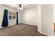 Carpeted bedroom with a window with curtains and a ceiling fan with light fixture at 8113 Danaides Ct, Las Vegas, NV 89131