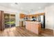 Bright kitchen featuring an island, stainless steel appliances, and sliding door to backyard at 8113 Danaides Ct, Las Vegas, NV 89131