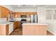 Bright kitchen with stainless steel appliances, wooden cabinets, and an island at 8113 Danaides Ct, Las Vegas, NV 89131