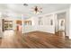 Open concept living room with wood flooring and views of the kitchen and backyard at 8113 Danaides Ct, Las Vegas, NV 89131
