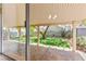 Covered patio overlooks landscaped backyard with artificial grass, trees, and flowers at 8113 Danaides Ct, Las Vegas, NV 89131