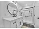 Bathroom with white cabinets, quartz countertop, and tiled shower at 823 Spikenard Dr, Henderson, NV 89002