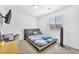 Bedroom features a horizontal-slat window, neutral carpet, and TV mounted on the wall at 823 Spikenard Dr, Henderson, NV 89002