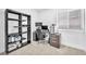 Bedroom features a large window, neutral carpet, and dark wood bookshelf at 823 Spikenard Dr, Henderson, NV 89002
