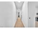 Hallway with neutral paint, modern baseboards, and laminate flooring at 823 Spikenard Dr, Henderson, NV 89002