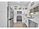 Renovated kitchen with stainless steel appliances and white cabinets at 823 Spikenard Dr, Henderson, NV 89002