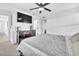 Bright main bedroom features a ceiling fan and dark wood dresser under a wall-mounted television at 823 Spikenard Dr, Henderson, NV 89002