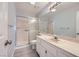 Bathroom featuring tiled floors, a shower with glass doors, and vanity with a large mirror at 8309 Windrush Ave, Las Vegas, NV 89117
