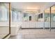 Bright bathroom with double vanities, tiled floor, separate shower, and large mirror at 8309 Windrush Ave, Las Vegas, NV 89117