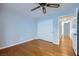 Cozy bedroom features a ceiling fan, hardwood floors, and white closet with sliding doors at 8309 Windrush Ave, Las Vegas, NV 89117