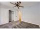 Bedroom with neutral carpet, ceiling fan, closet, and access door at 8309 Windrush Ave, Las Vegas, NV 89117