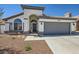 Attractive single-story home with a well-manicured front yard, arched entry, and two-car garage at 8309 Windrush Ave, Las Vegas, NV 89117