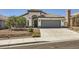 Inviting single-story house with a concrete driveway, desert landscaping, and attached two-car garage at 8309 Windrush Ave, Las Vegas, NV 89117
