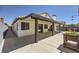 The rear exterior of the home has a patio, hardscape, and planting bed at 8309 Windrush Ave, Las Vegas, NV 89117