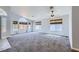 Bright living room featuring grey carpet, neutral walls, ceiling fan, and plenty of natural light at 8309 Windrush Ave, Las Vegas, NV 89117