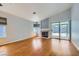 Spacious living room with wood floors, a fireplace, and a sliding glass door to the backyard at 8309 Windrush Ave, Las Vegas, NV 89117