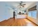Open-concept living room and kitchen with wood floors, updated appliances, and natural light at 8309 Windrush Ave, Las Vegas, NV 89117