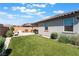 Open backyard with artificial lawn, tile roof, stucco walls and backyard seating area at 8351 Vinamala Ave, Las Vegas, NV 89149
