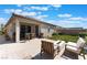 Wonderful backyard with patio, artificial grass, and seating area for entertaining guests at 8351 Vinamala Ave, Las Vegas, NV 89149