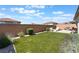 Beautiful backyard featuring an artificial lawn, a brick wall, and desert landscaping at 8351 Vinamala Ave, Las Vegas, NV 89149