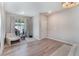 Cozy bedroom with plush seating area, wood-look floors and a sliding door to the outside at 8351 Vinamala Ave, Las Vegas, NV 89149