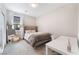 Cozy bedroom is staged with a plush bed, desk, and a full length mirror at 8351 Vinamala Ave, Las Vegas, NV 89149