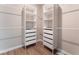 A closet features open shelving and drawers for ample storage with wood-look floors at 8351 Vinamala Ave, Las Vegas, NV 89149
