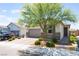 Inviting single-story home with landscaped front yard, desert foliage, and brick accents at 8351 Vinamala Ave, Las Vegas, NV 89149