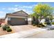 Attractive one-story home featuring a two-car garage and desert landscaping at 8351 Vinamala Ave, Las Vegas, NV 89149