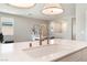 Open concept kitchen featuring quartz countertops, stainless steel appliances, and modern fixtures at 8351 Vinamala Ave, Las Vegas, NV 89149