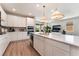 Modern kitchen with stainless steel appliances, central island, white cabinets, and an open floor plan at 8351 Vinamala Ave, Las Vegas, NV 89149