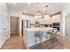 A modern kitchen with an island, bar stools, stainless steel appliances, and pendant lighting at 8351 Vinamala Ave, Las Vegas, NV 89149