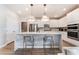 Modern kitchen featuring stainless steel appliances, quartz countertops and a center island with seating at 8351 Vinamala Ave, Las Vegas, NV 89149