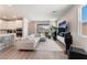 Spacious living room boasts an open floorplan, recessed lights, and a large screen television at 8351 Vinamala Ave, Las Vegas, NV 89149