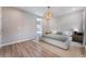 Spacious bedroom with neutral walls, wood-look flooring, and lots of natural light at 8351 Vinamala Ave, Las Vegas, NV 89149