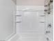 Modern tub and shower combination with built in shelving in neutral bathroom at 8351 Vinamala Ave, Las Vegas, NV 89149