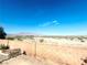 Expansive backyard with desert landscaping and mountain views beyond the brick fence at 8616 Willow Cabin St, Las Vegas, NV 89131
