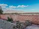 Secluded backyard view featuring a brick fence and serene desert landscape at 8616 Willow Cabin St, Las Vegas, NV 89131