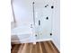 The modern bathroom has a separate tub and shower with black hardware at 8616 Willow Cabin St, Las Vegas, NV 89131