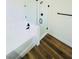 Close-up of a bathroom with wood-look floors showcasing a tub next to a glass-enclosed shower at 8616 Willow Cabin St, Las Vegas, NV 89131