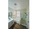 Well-lit bathroom with tub, glass shower, and updated vanity at 8616 Willow Cabin St, Las Vegas, NV 89131